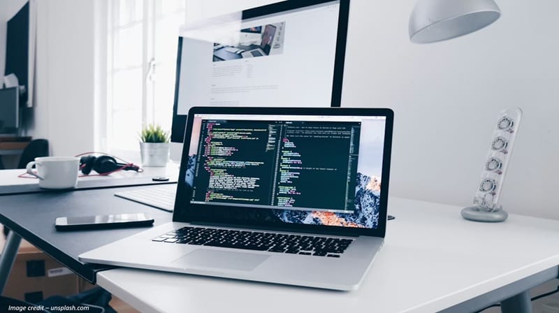 MacBook with lines of code